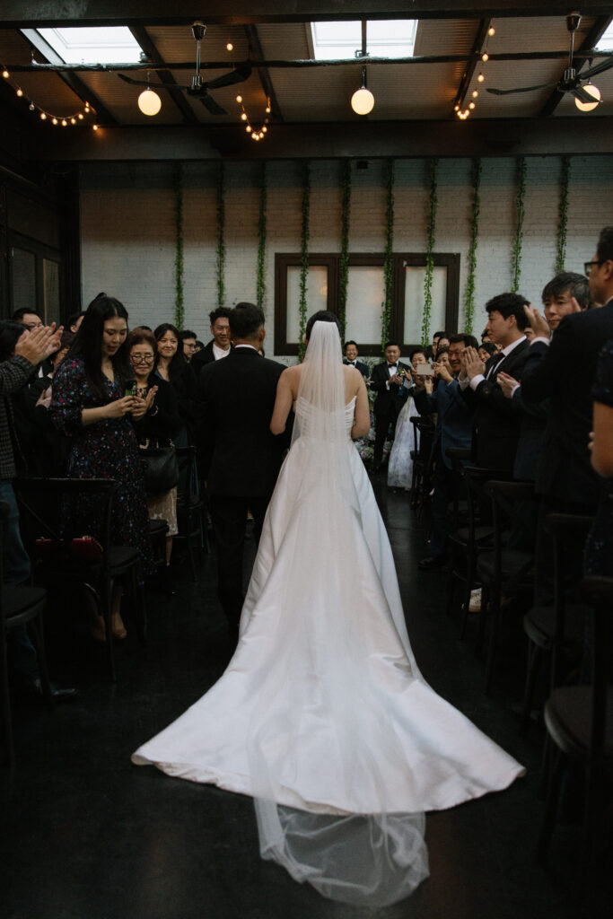Bride walking down the aisle from behind