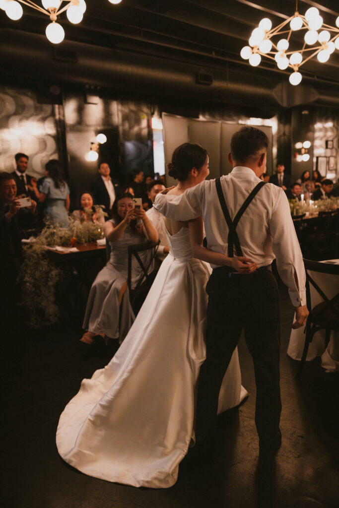 bride and father from behind during the wedding reception