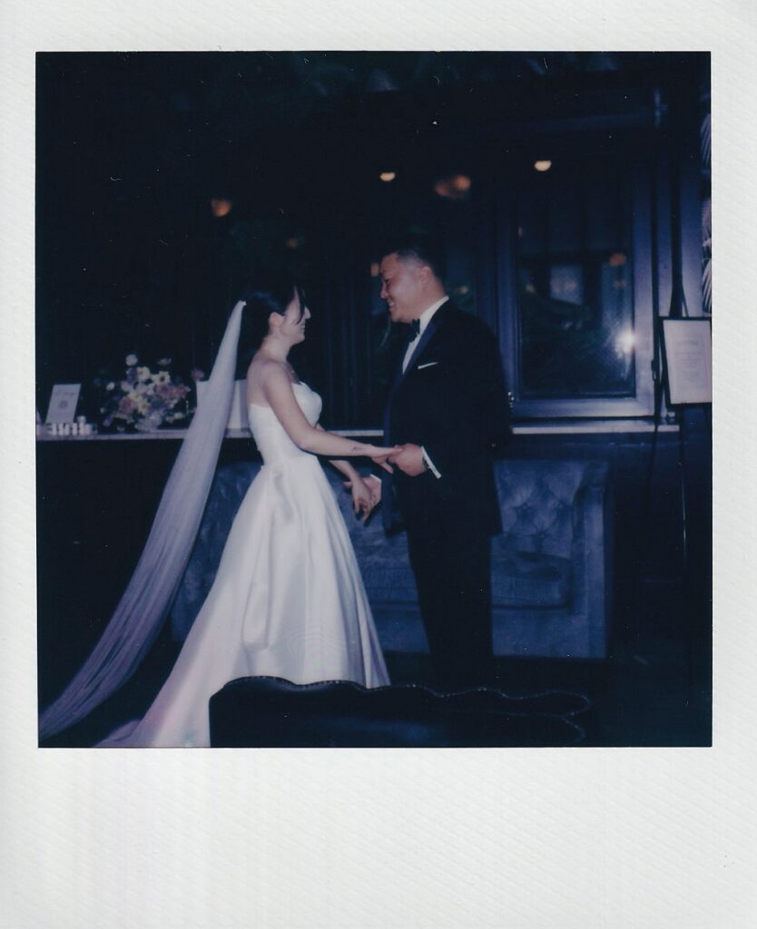 Polaroid of first look with bride and groom