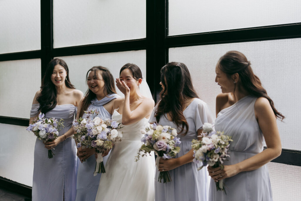 Bride laughing with bridesmaids