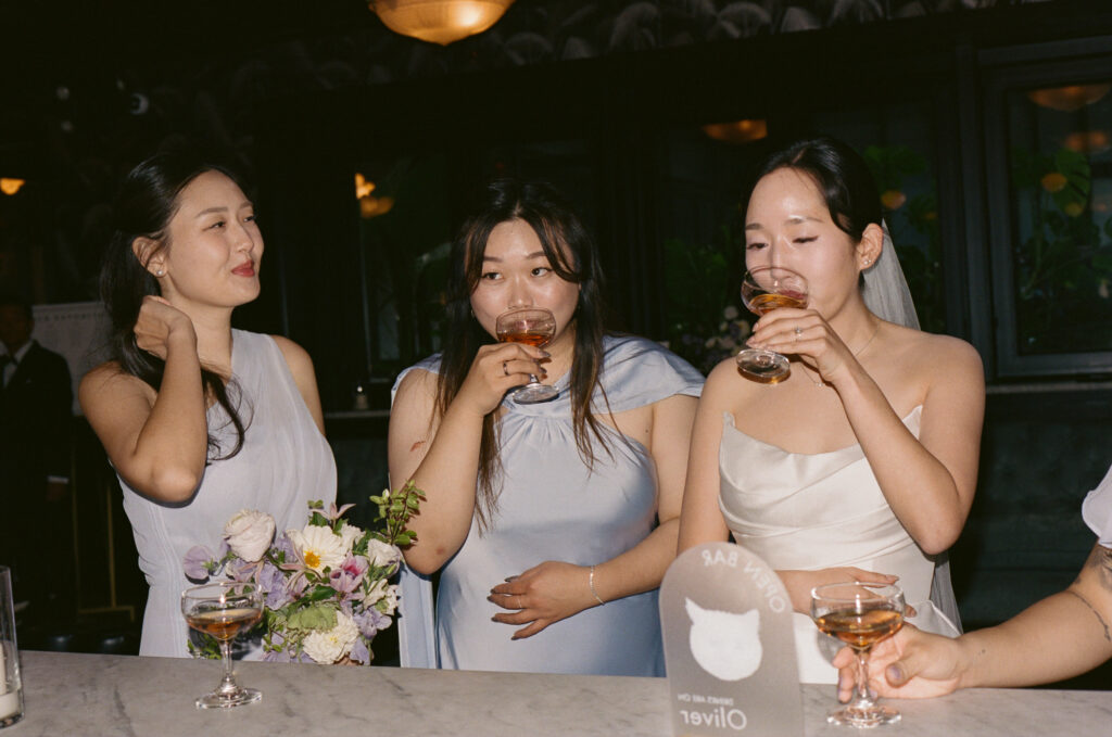 Bride having a drink with her bridesmaids