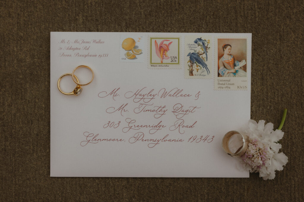 Flat Lay of Wedding Invite Envelope and Wedding Rings