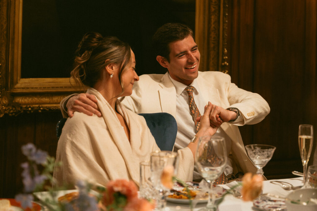 Bride and Groom Smiling and Laughing at Rehearsal Dinner