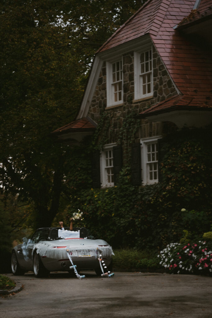 Bride and groom driving away in getaway car 