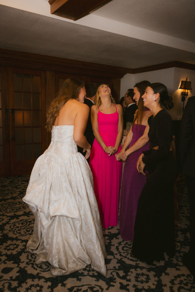 Bride laughing with wedding guests at the reception