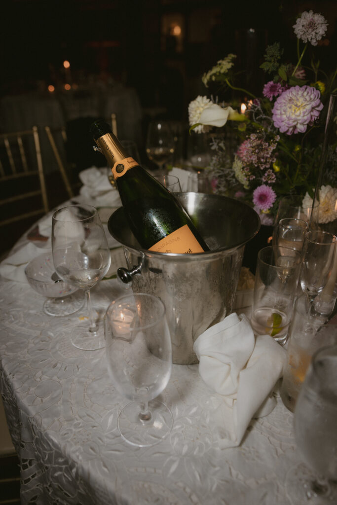 Champagne bottle in an ice bucket during wedding reception