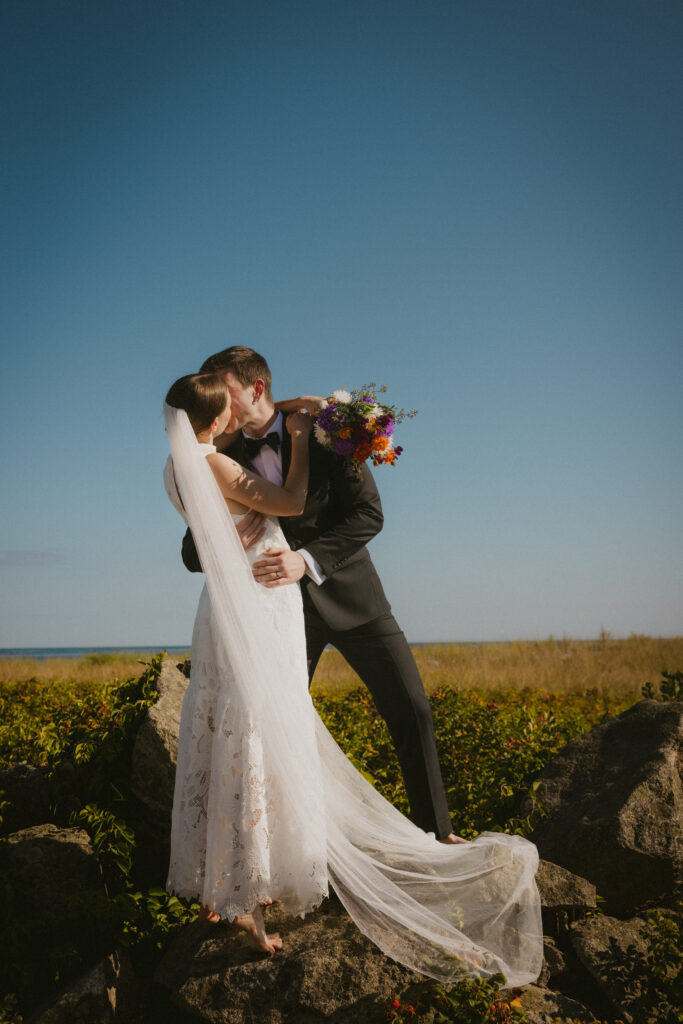 Bride and groom kissing at Goose Rocks Beach