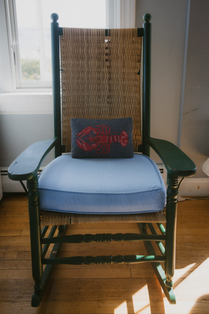 Rocking chair with blue cushion and lobster needlepoint pillow 