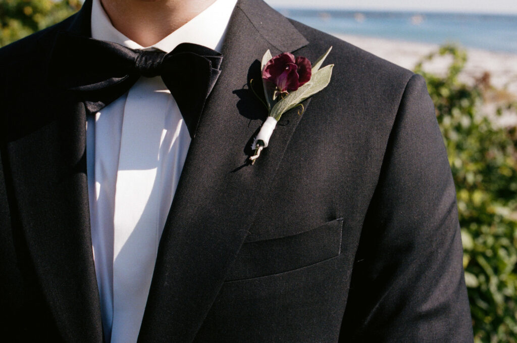 Detail shot of groom's suit and boutonniere 