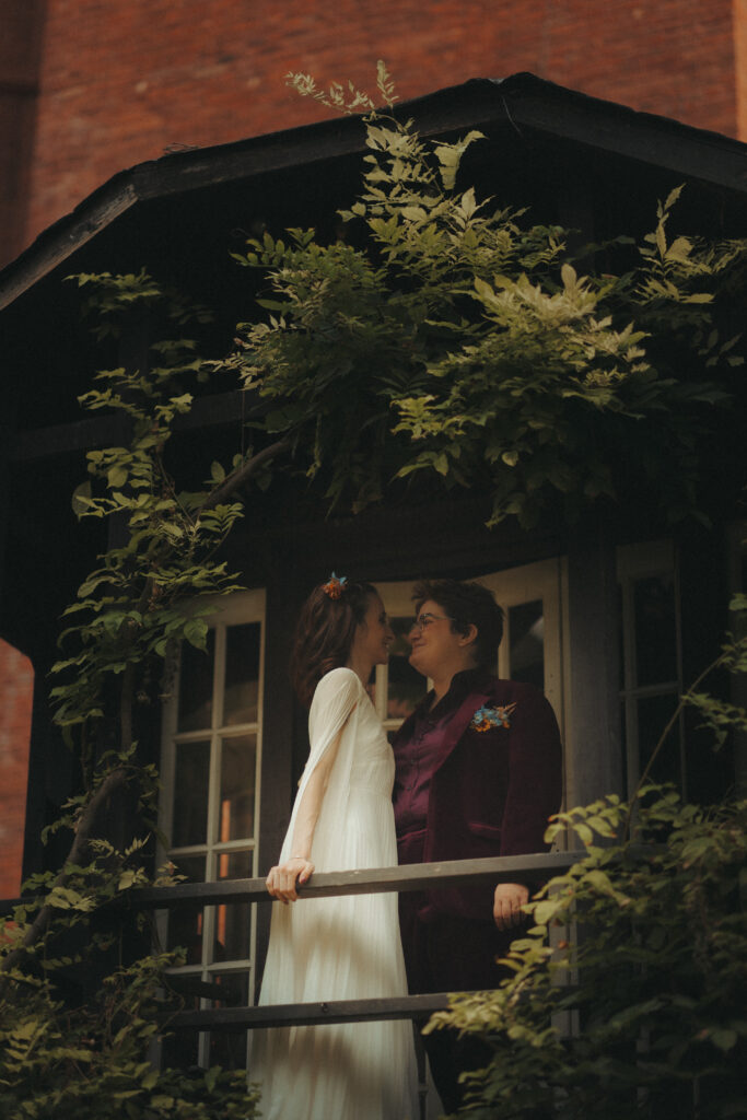 Brides standing on a balcony looking at each other