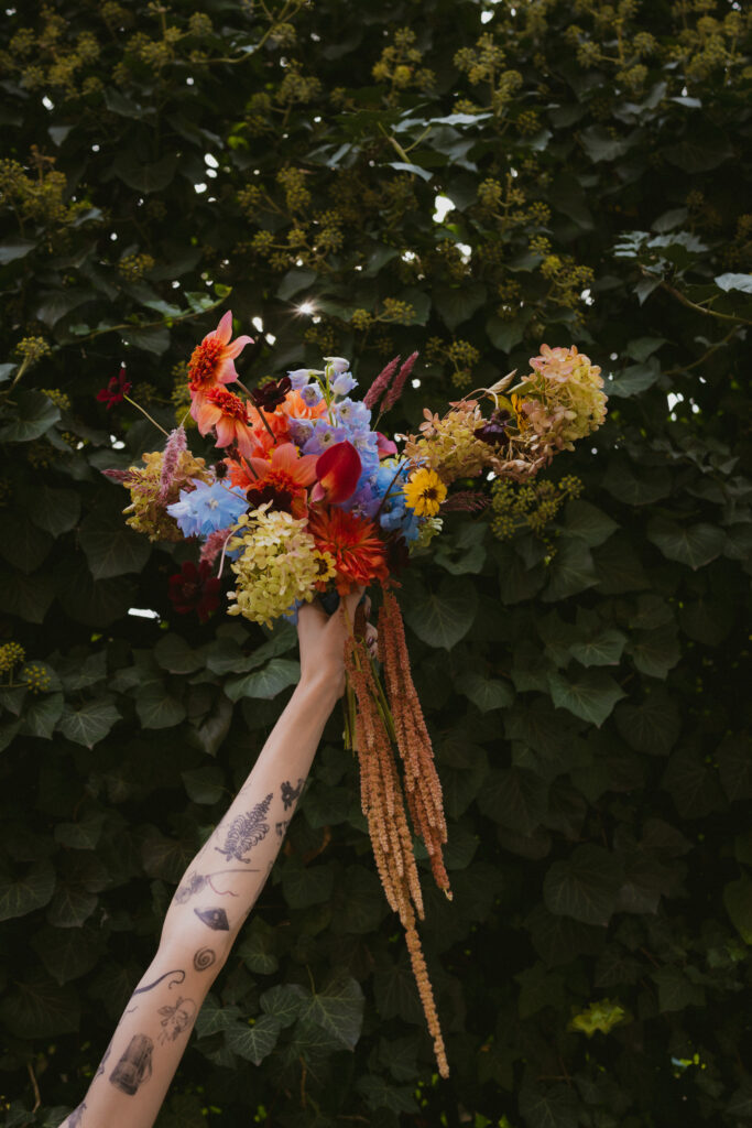 Close up of bride holding her bouquet in the air 