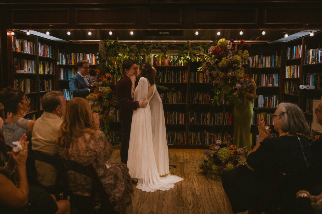 Brides' first kiss as a married couple during their housing works bookstore wedding ceremony
