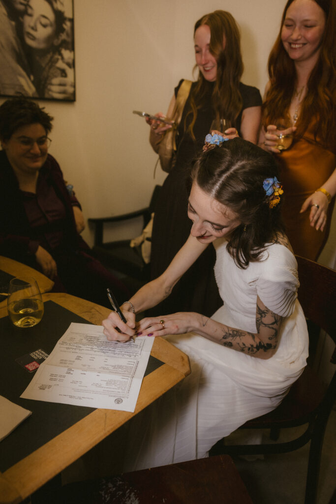 Bride signing the marriage license 