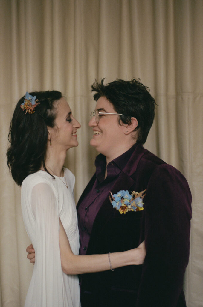 Brides looking at each other during first look and smiling