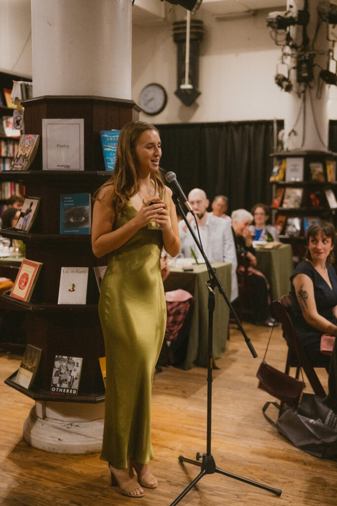 Maid of honor giving a toast at a housing works bookstore wedding