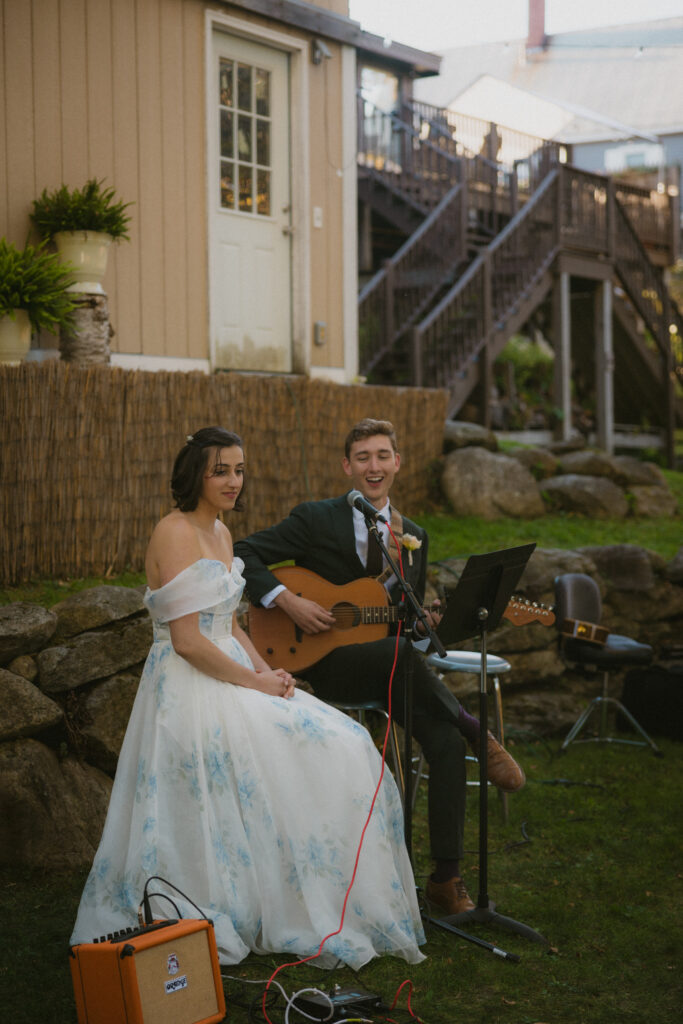 Bride and groom performing a musical number during the reception
