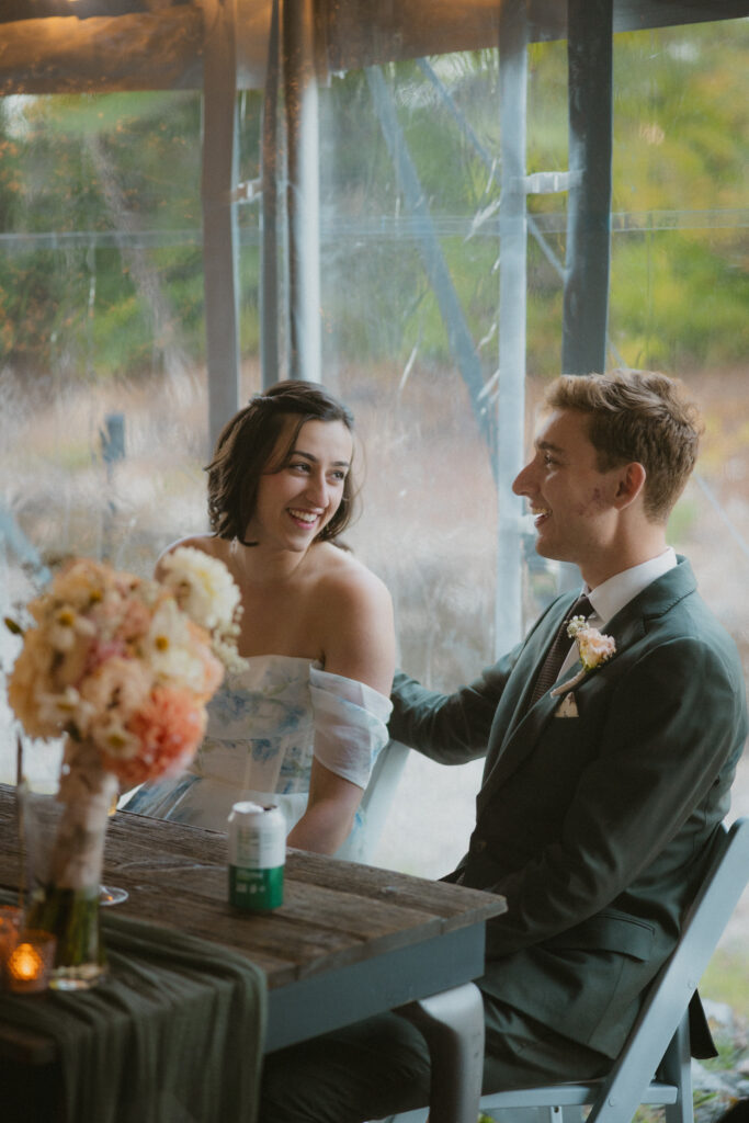 Bride and groom laughing during wedding reception