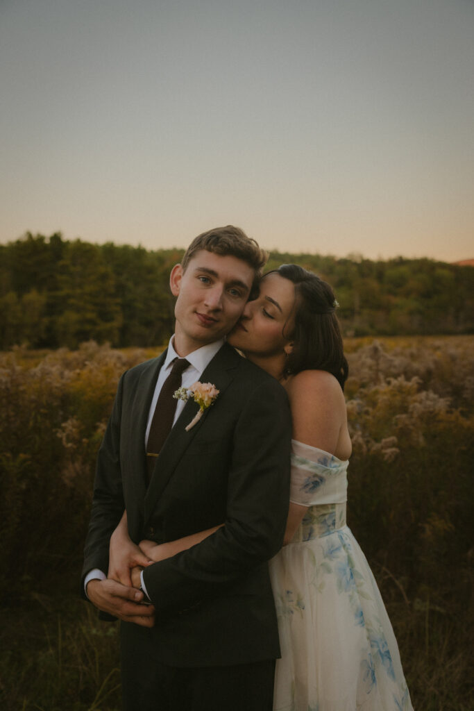 Close up of bride and groom standing in a wildflower meadow