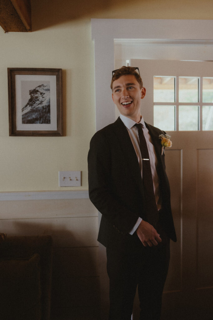 Groom smiling during first look