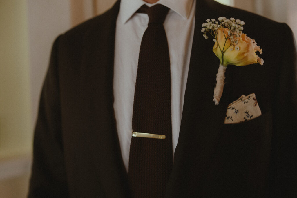 Close up of groom's suit and boutonniere 