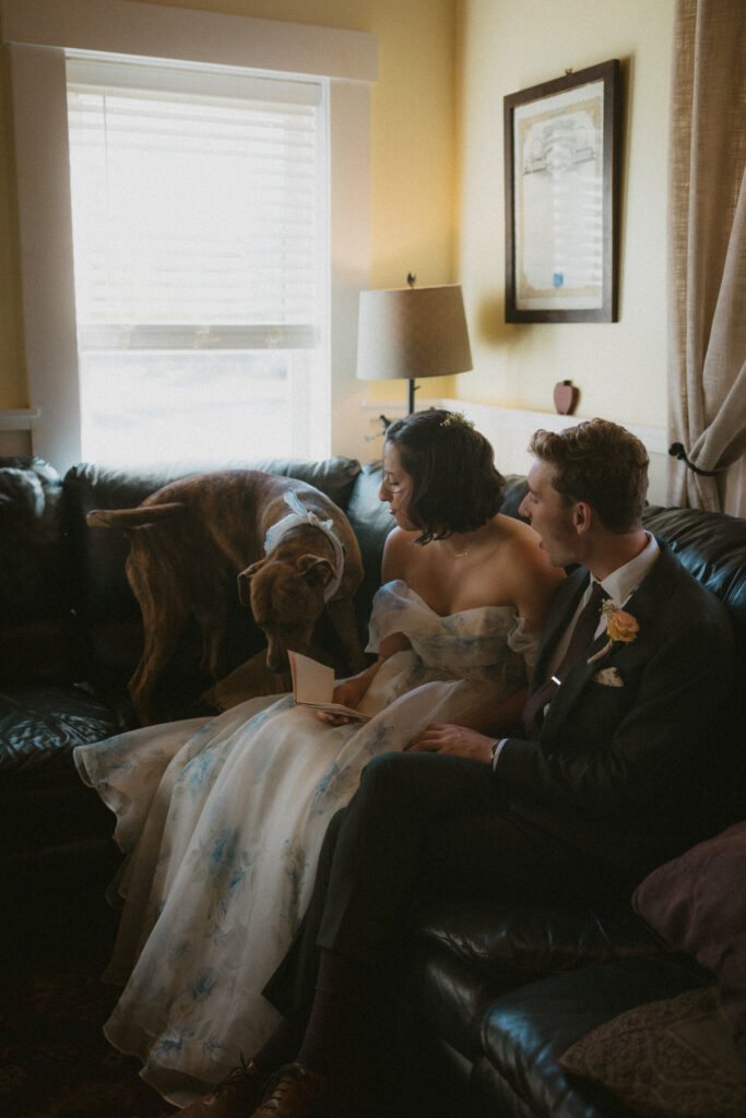 Bride and groom looking at their dog while sharing private vows