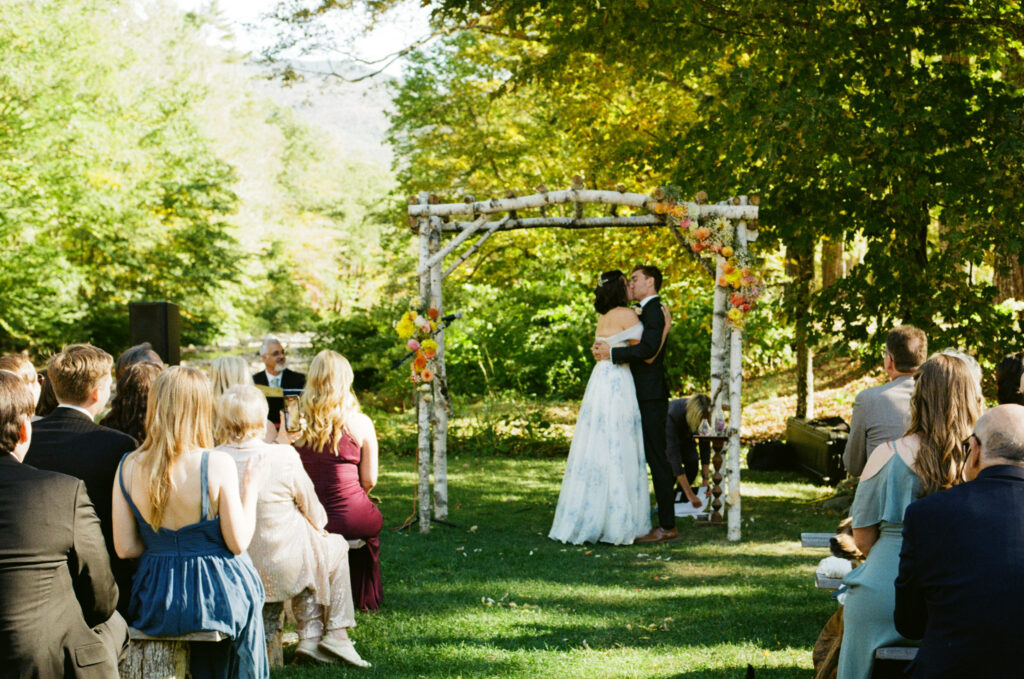 Bride and groom sharing their first kiss as a married couple