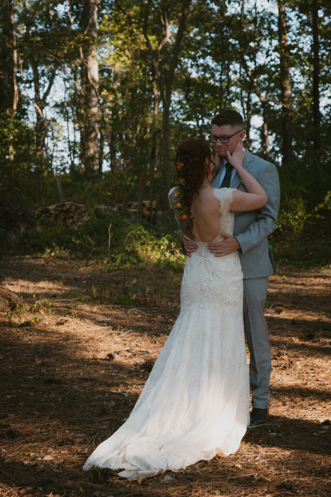 Bride and groom at their first look in the woods