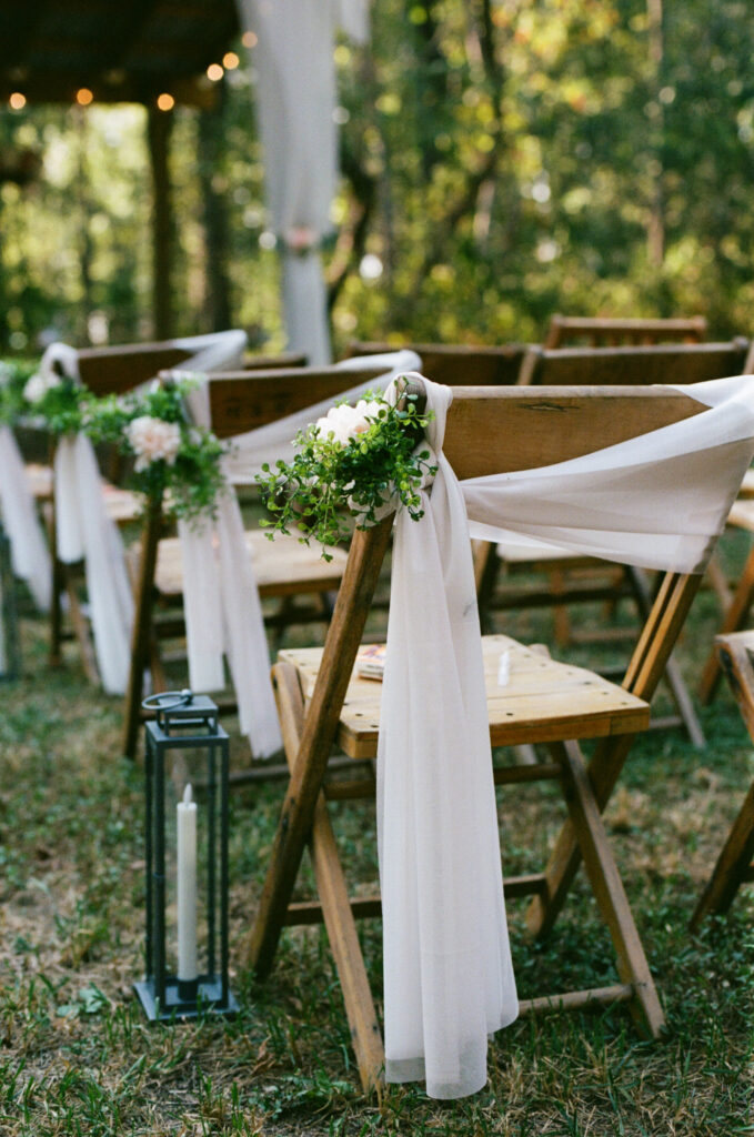 Close up of an aisle chair at a summer camp wedding ceremony