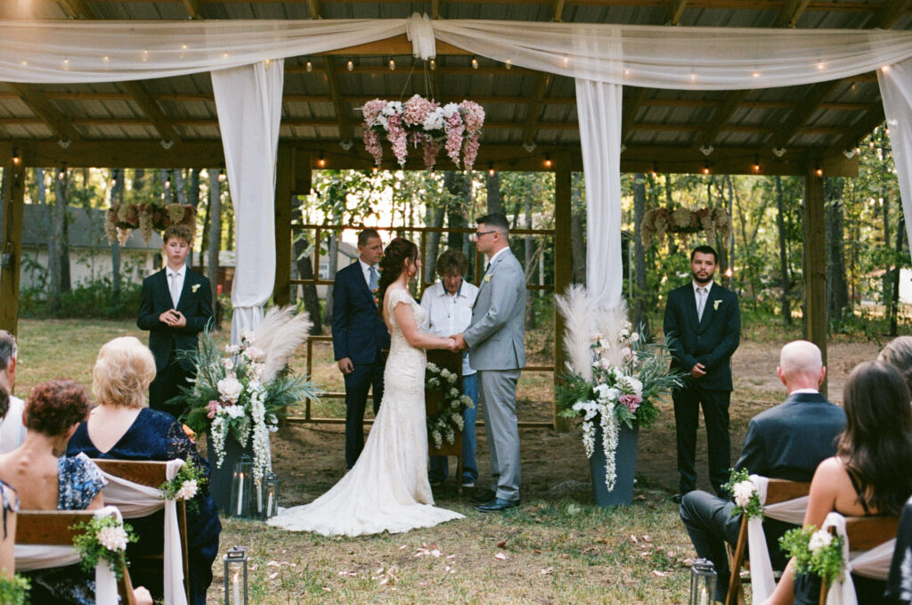 Bride and groom at the altar of a summer camp wedding
