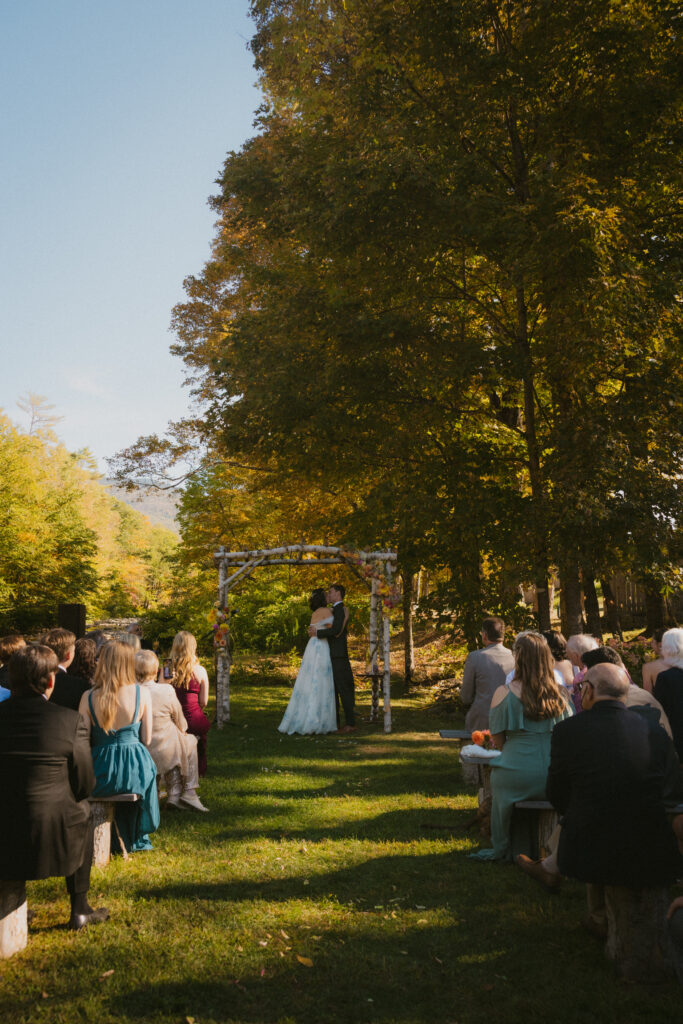 Bride and groom kissing during the wedding ceremony