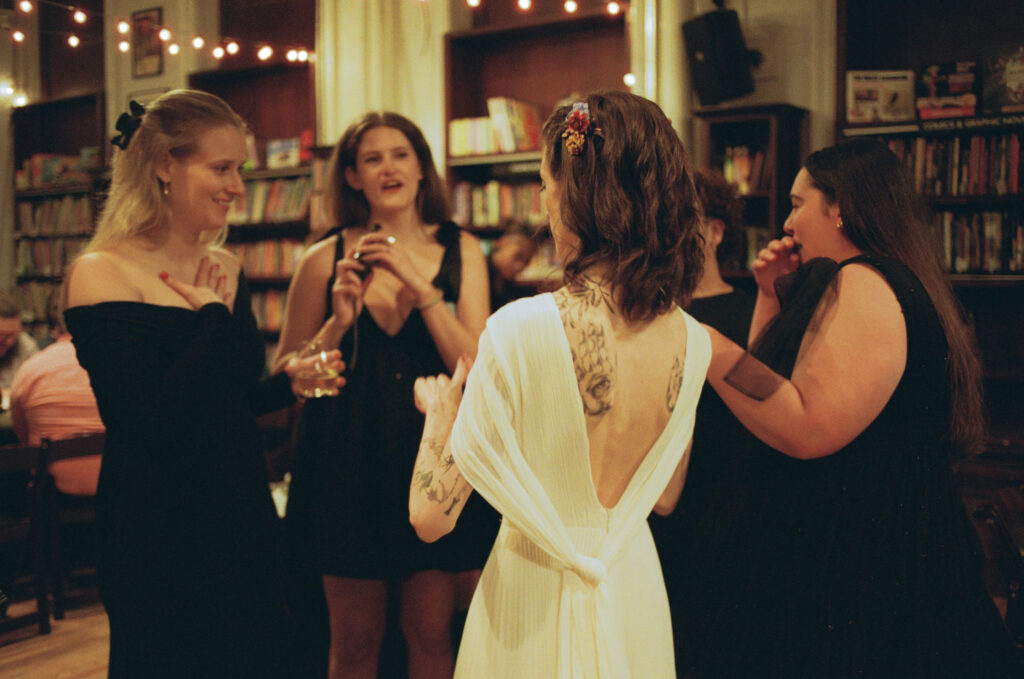 Film photo of bride interacting with guests at her housing works bookstore wedding 