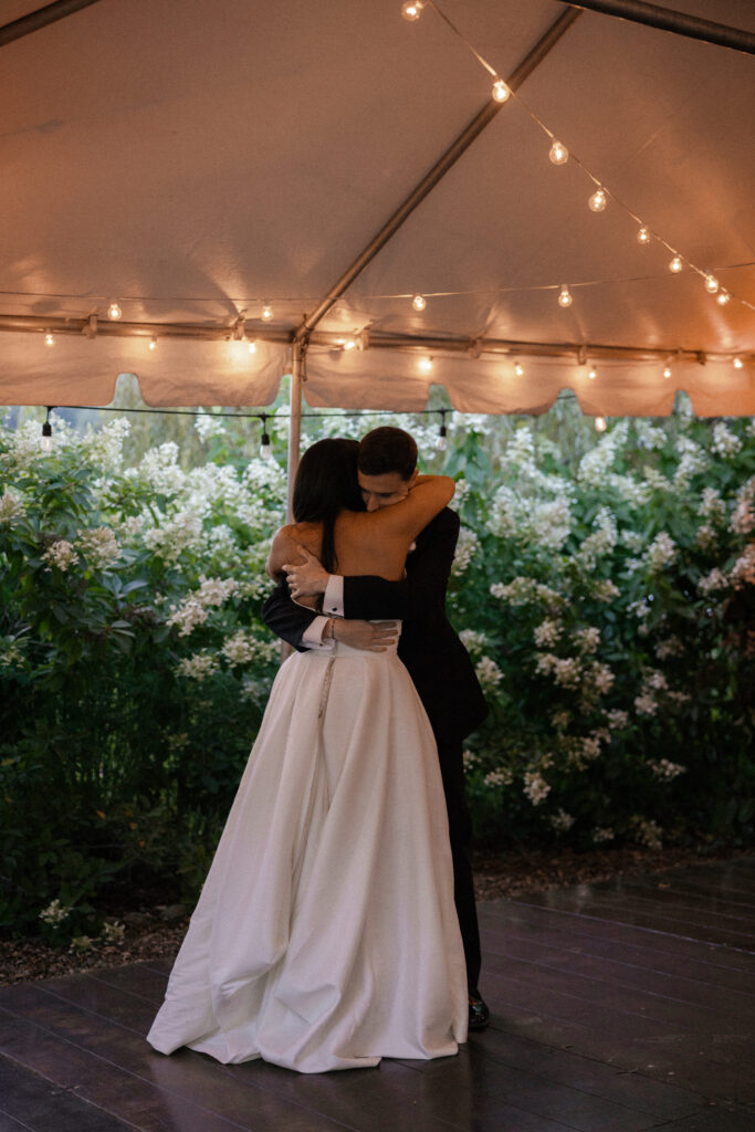 Bride and groom's first dance in a tented reception space