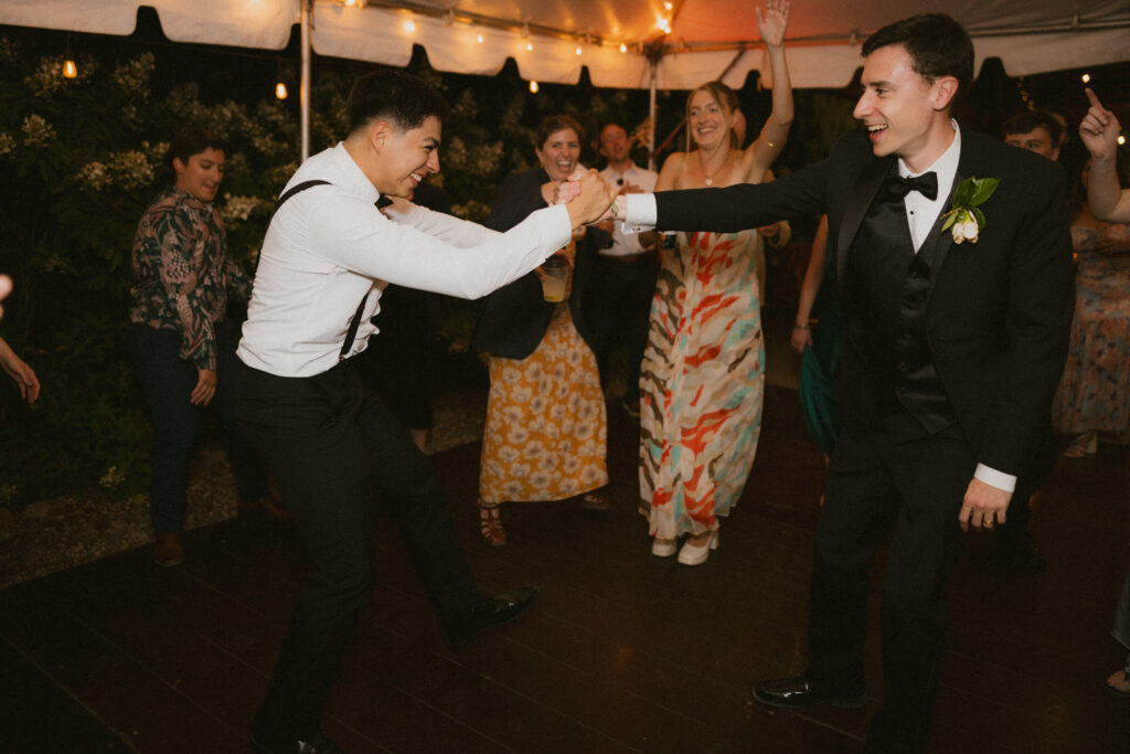 Groom and groomsman dancing on the dance floor 