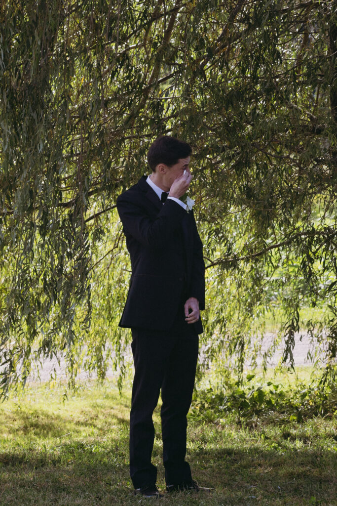 Groom crying at seeing the bride walk down the aisle 