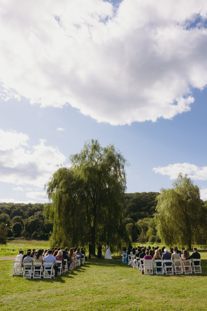 Bride and groom standing at the altar during the ceremony at a New England farm wedding 