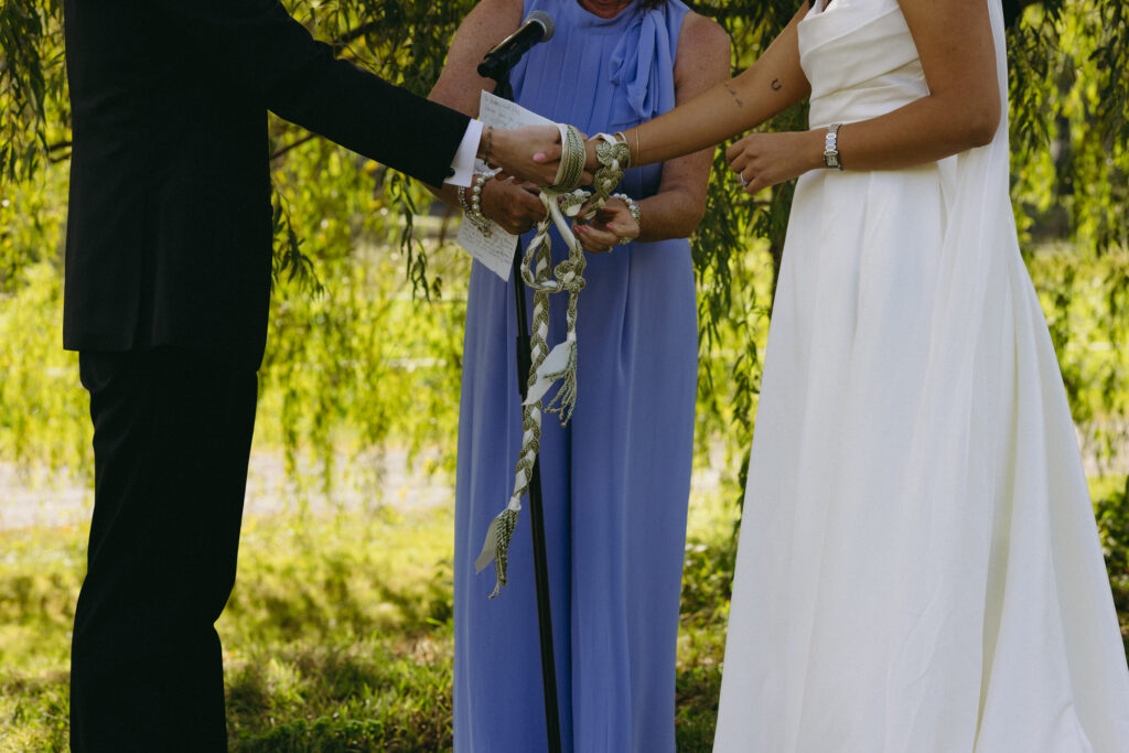 Close up shot of a hand fasting ceremony at a wedding