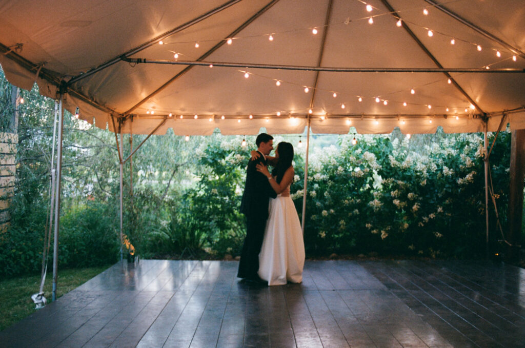 Bride and groom's first dance in a tented reception space