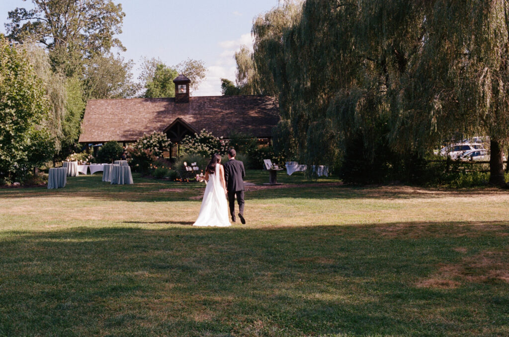 Bride and groom from afar walking together during the reception
