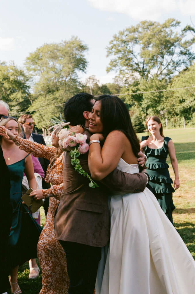 Bride hugging a wedding guest at the reception