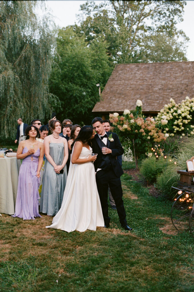 Candid shot of the bride and groom talking to each other during a New England farm wedding
