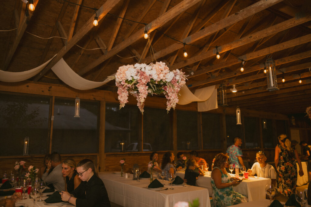 Reception space with wedding guests at a summer camp wedding