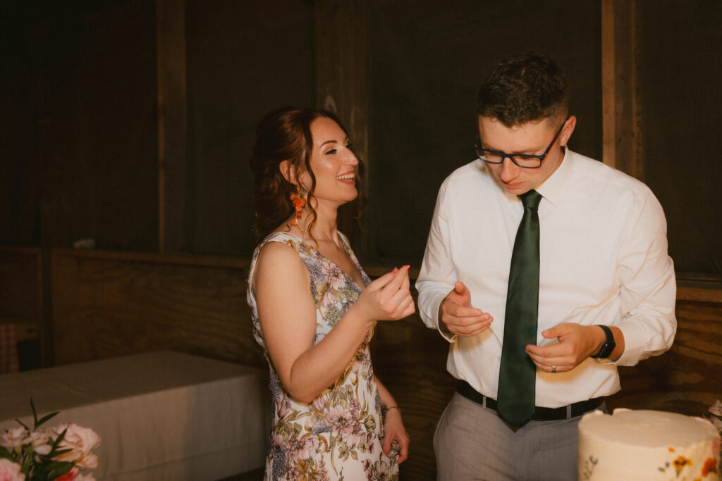 Bride and groom laughing after cutting the cake
