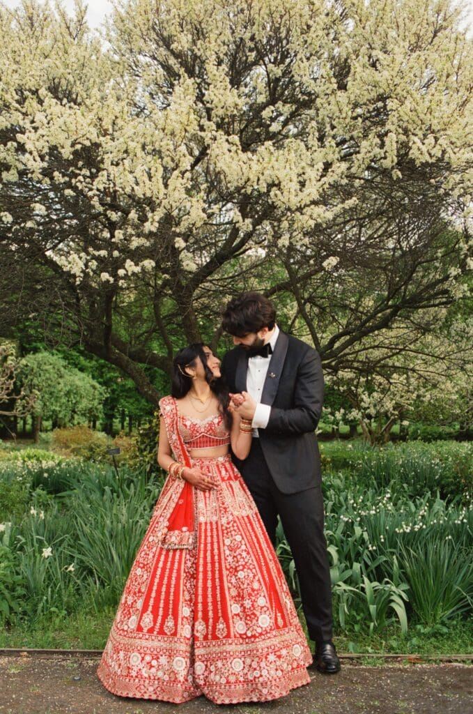 Bride and groom looking at each other in a garden