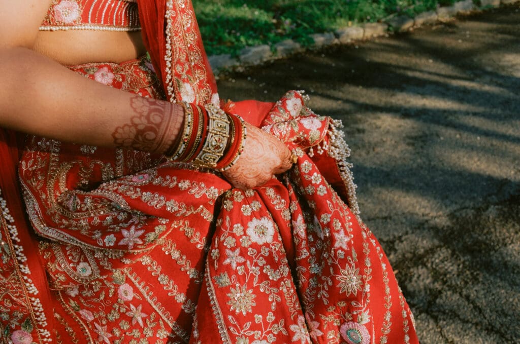 Close up of the bride holding up her wedding dress walking to the first look