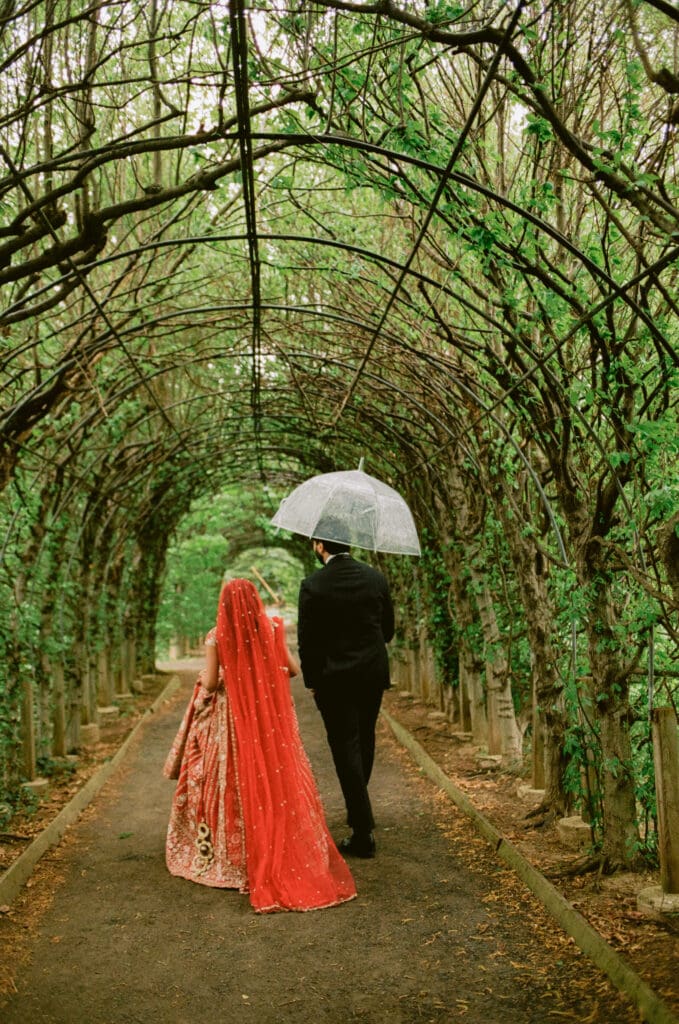 Bride and groom walking together after the first look at a Hindu Jewish wedding
