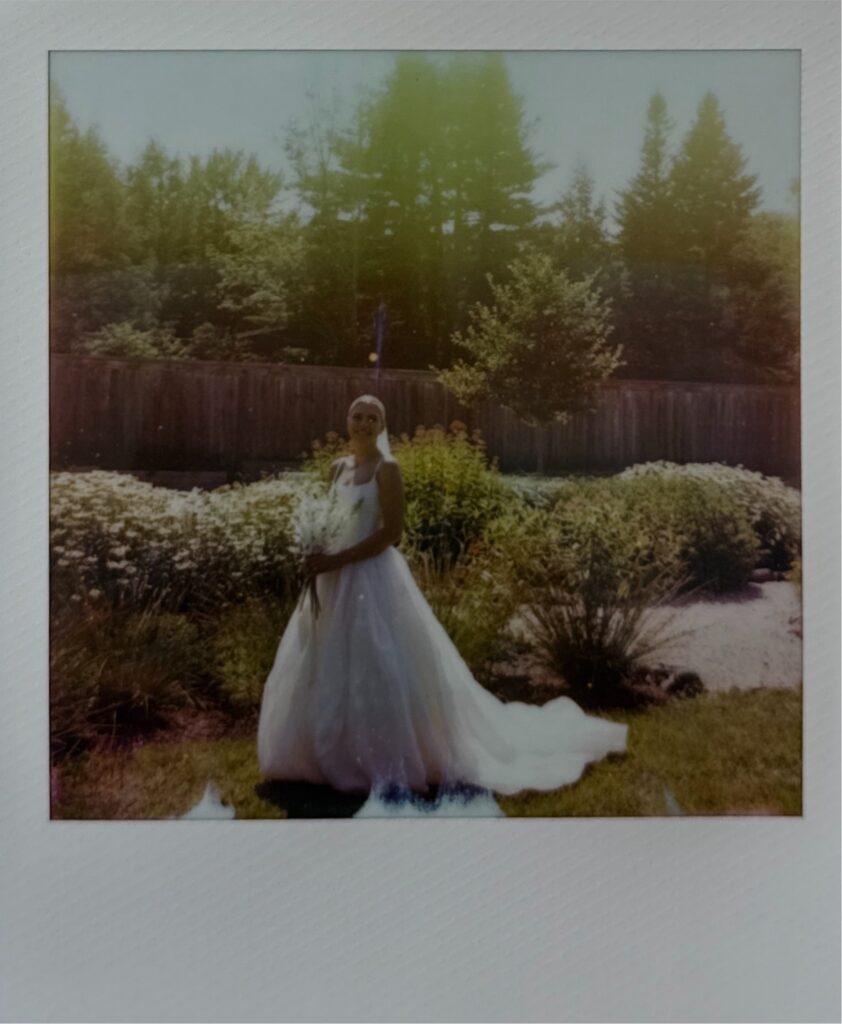 Polaroid of the bride in a flower garden