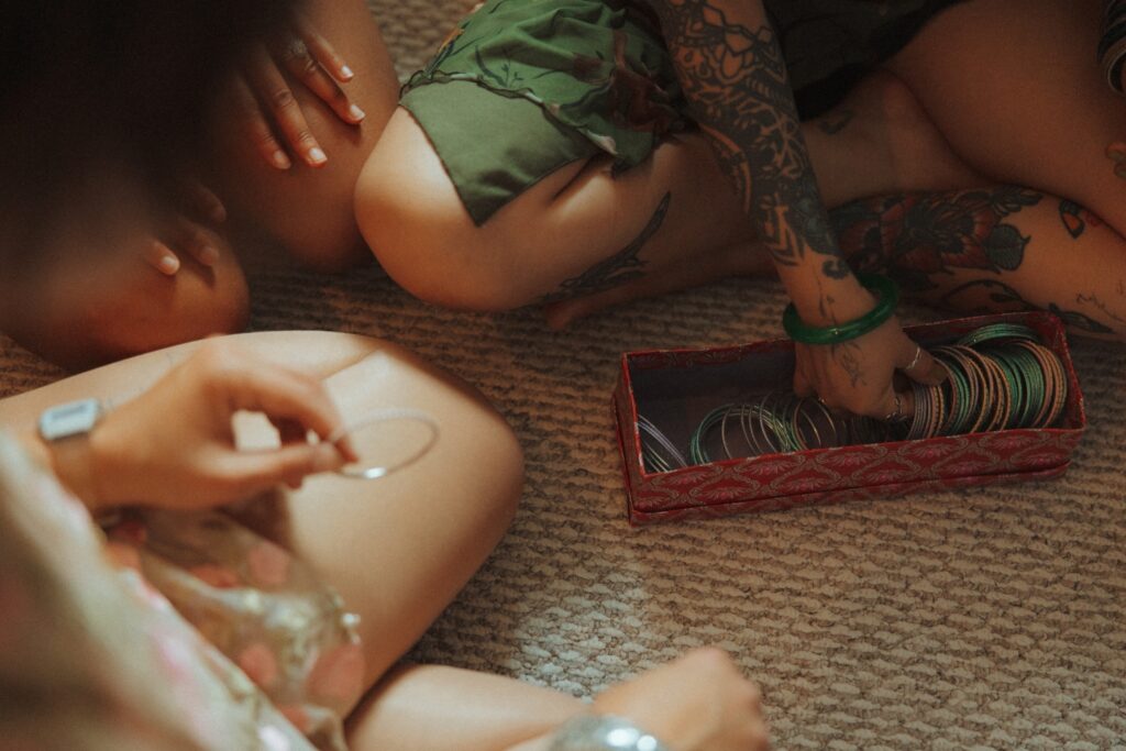 Bridesmaids putting on bangles