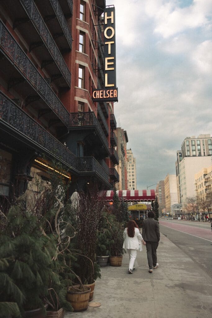 Bride and groom walking by The Chelsea Hotel