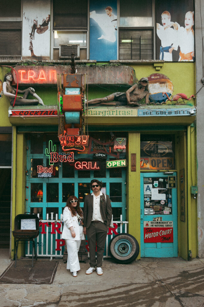 Bride and groom standing outside Trailer Park Lounge