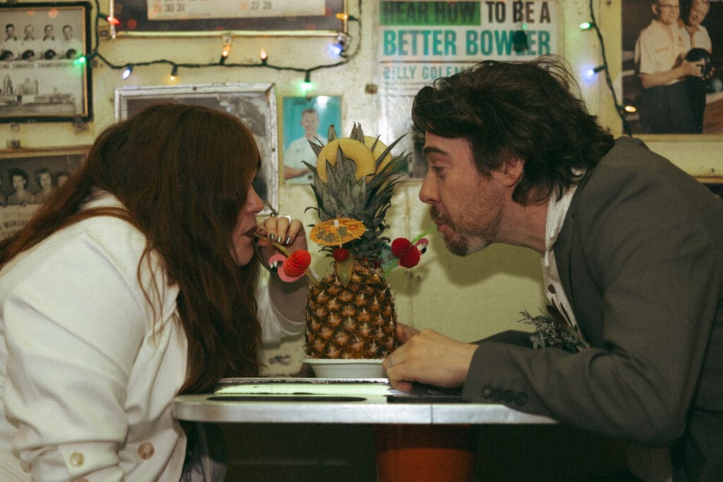 Bride and groom sharing a pineapple drink at Trailer Park Lounge